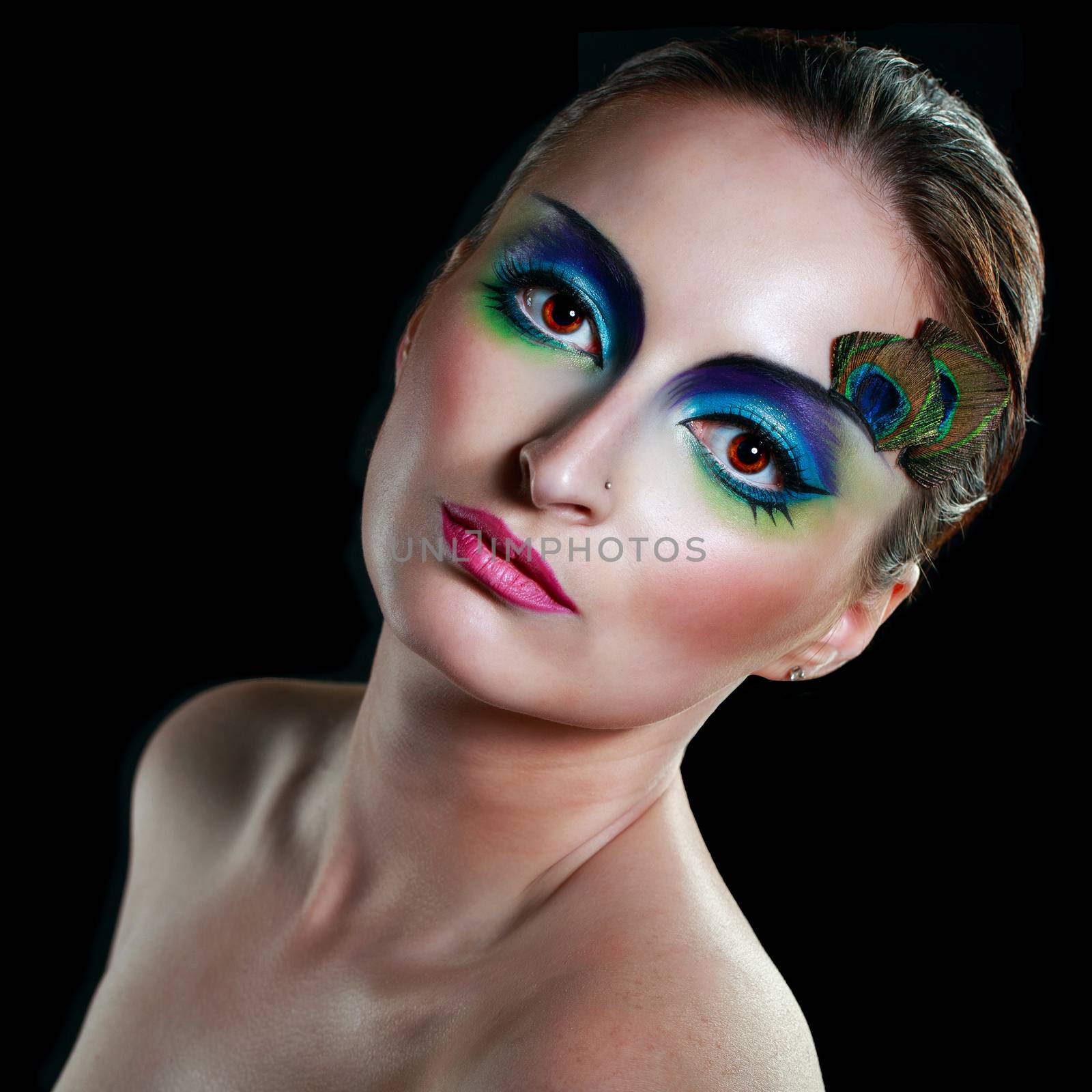 Attractive young girl with makeup peacock bird closeup portrait