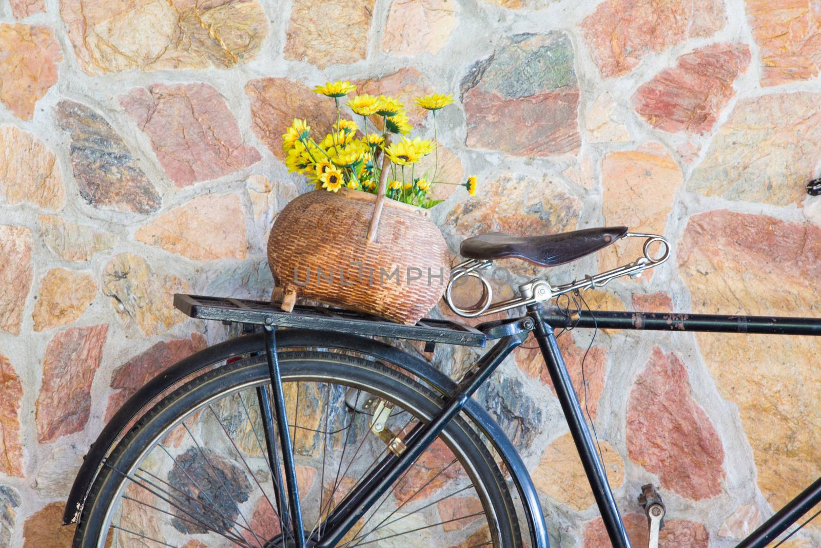 Antique bicycle with flowers.