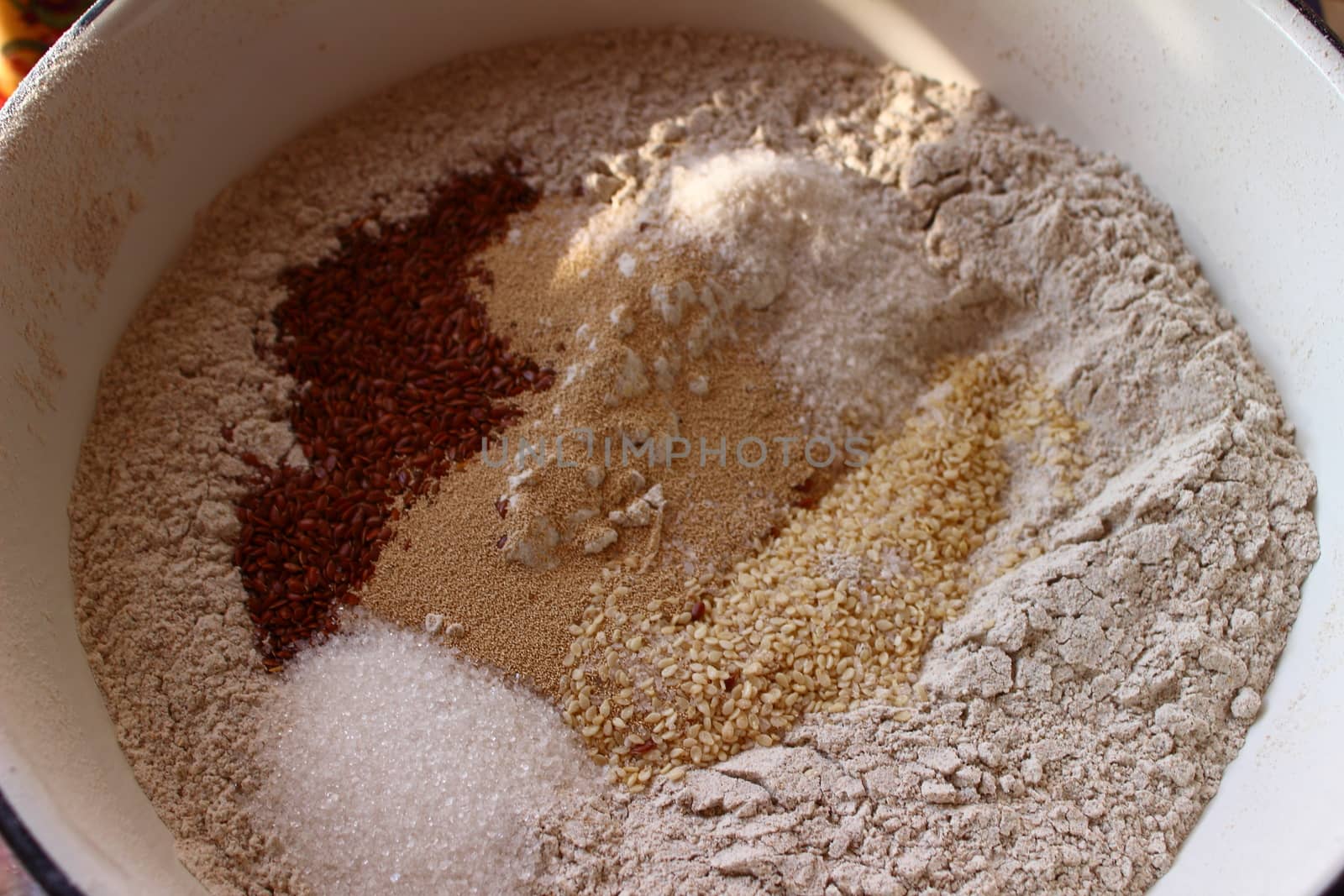 in white enamel bowl blanks for bread flour, salt, sugar, yeast, flax seeds, sesame seeds