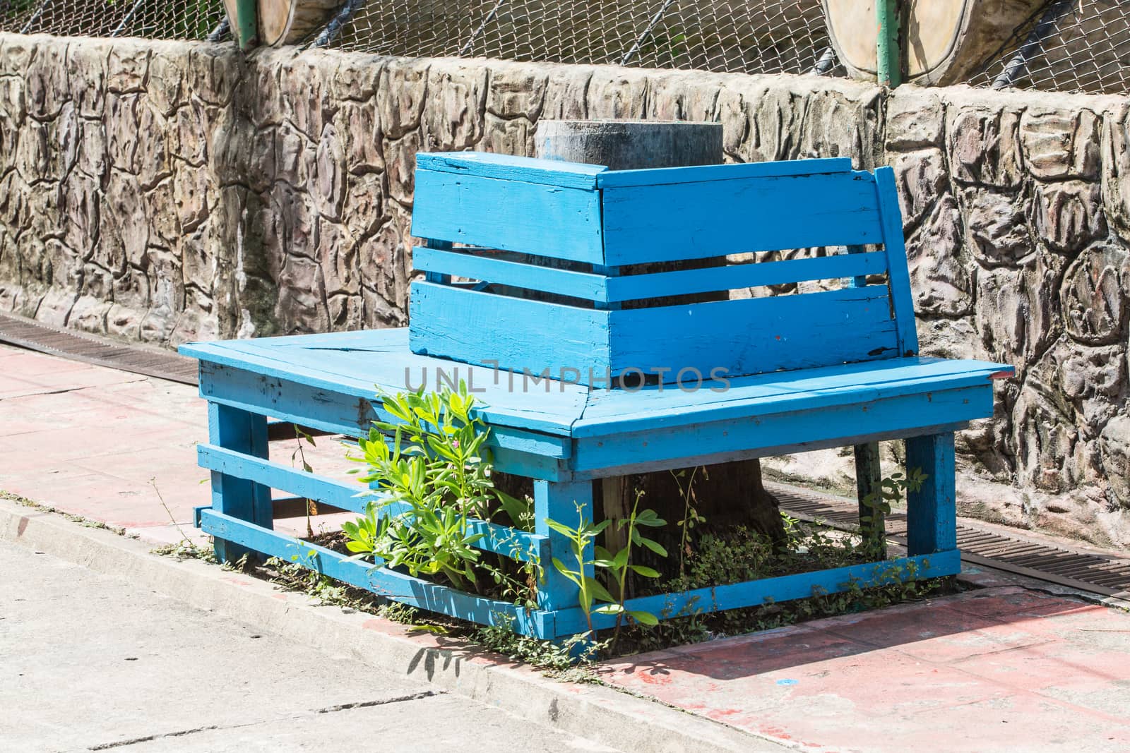 Chair on the side of the footpath.