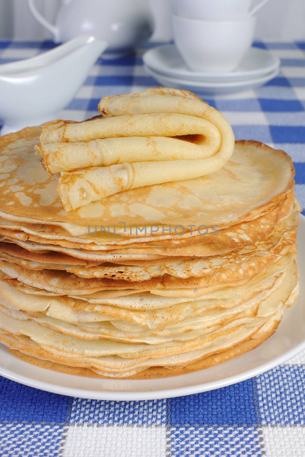 stack of pancakes on the table by Apolonia