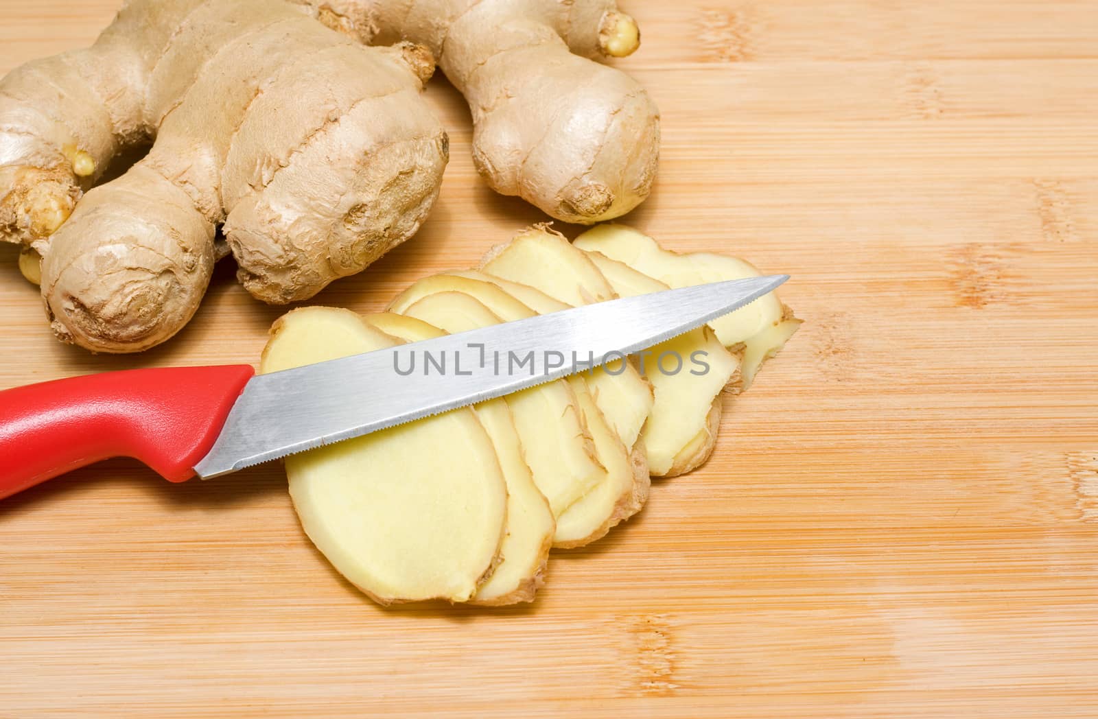 Ginger root on a bamboo chopping block