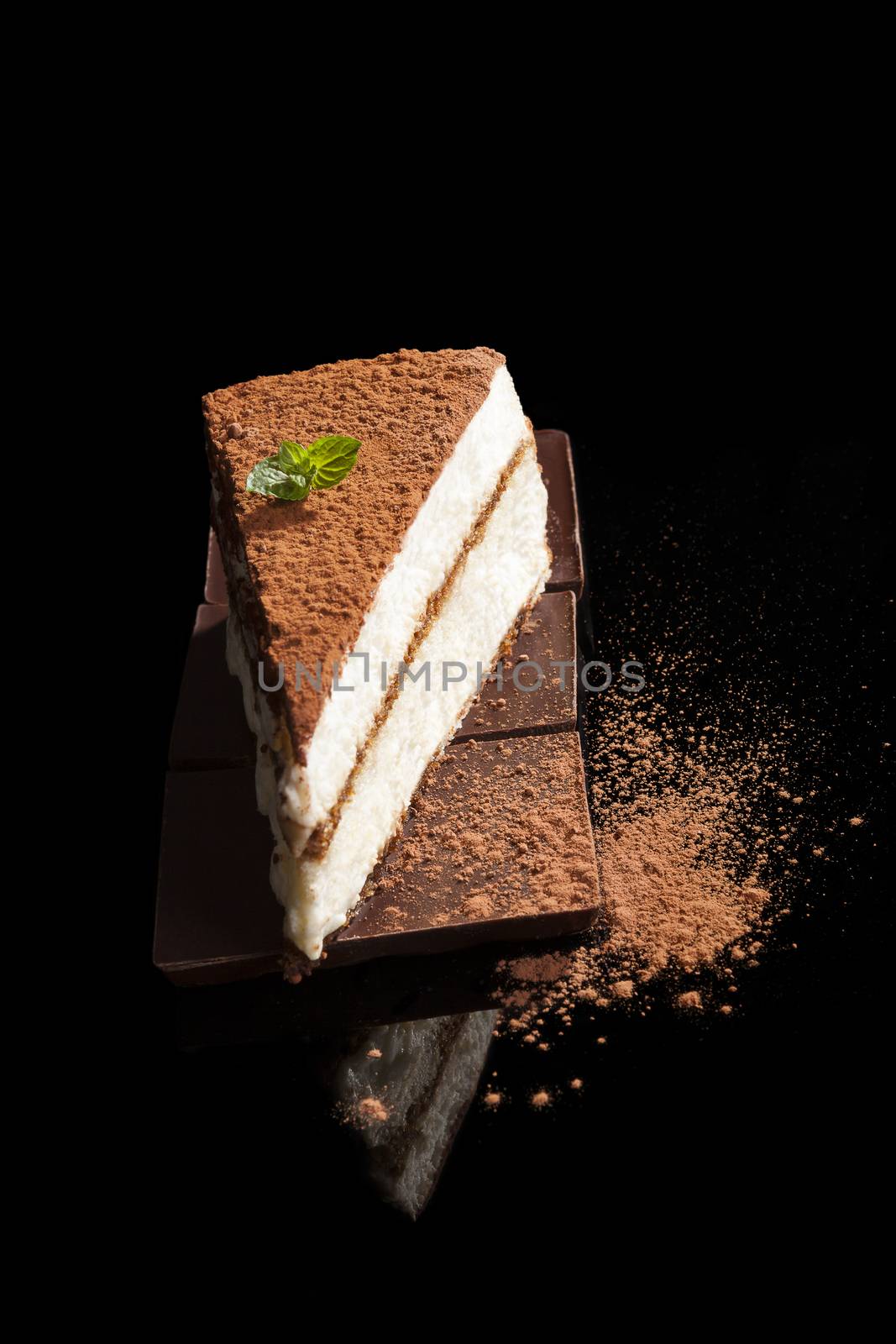 Tiramisu dessert on chocolate bar isolated on black background. Italian sweet dessert concept.