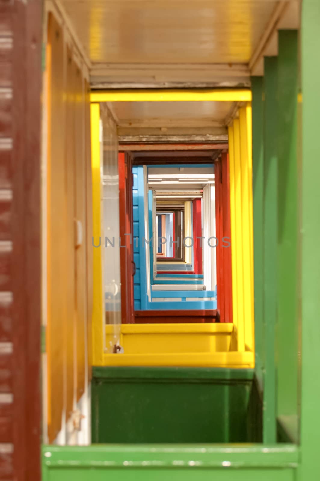 vanishing point of colorful beach hut doorways