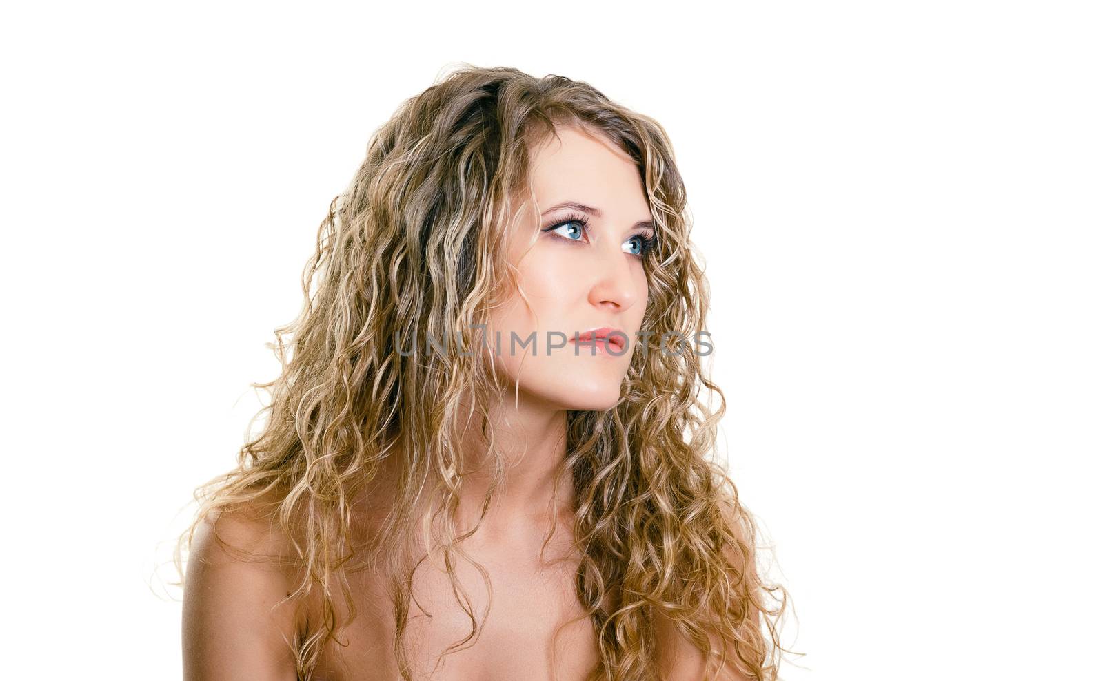 portrait of a beautiful young girl with long blond wavy hair. isolated on white