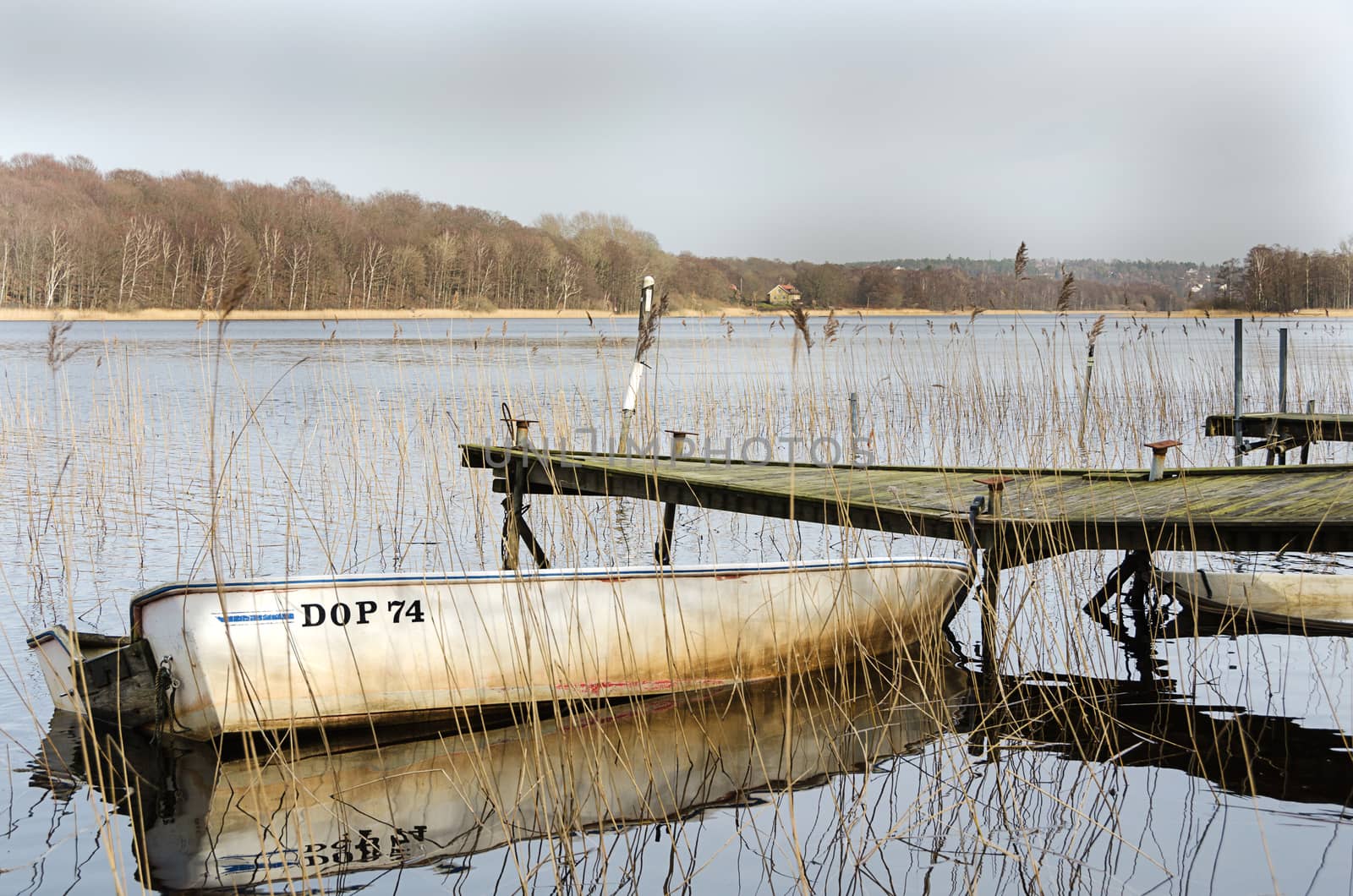 old dilapidated bridge with one old boats