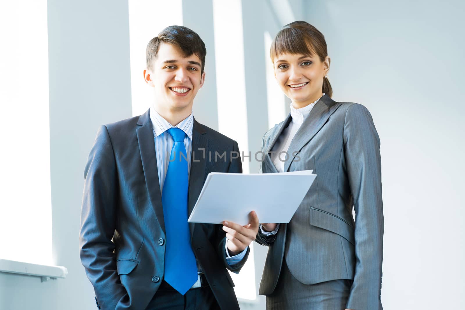 two business partners discussing documents in a bright office