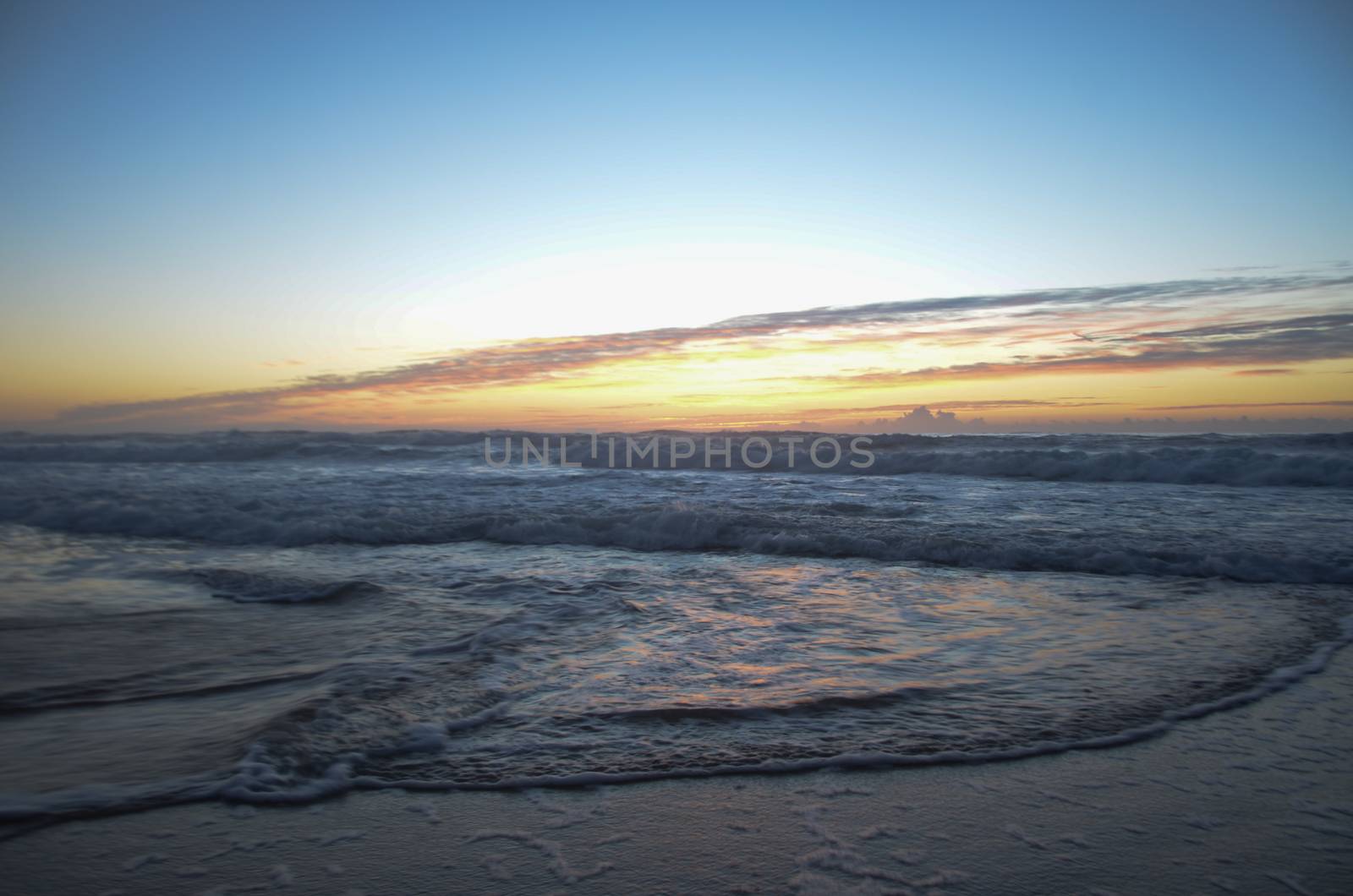 Beach, water under sunset scene in portugal