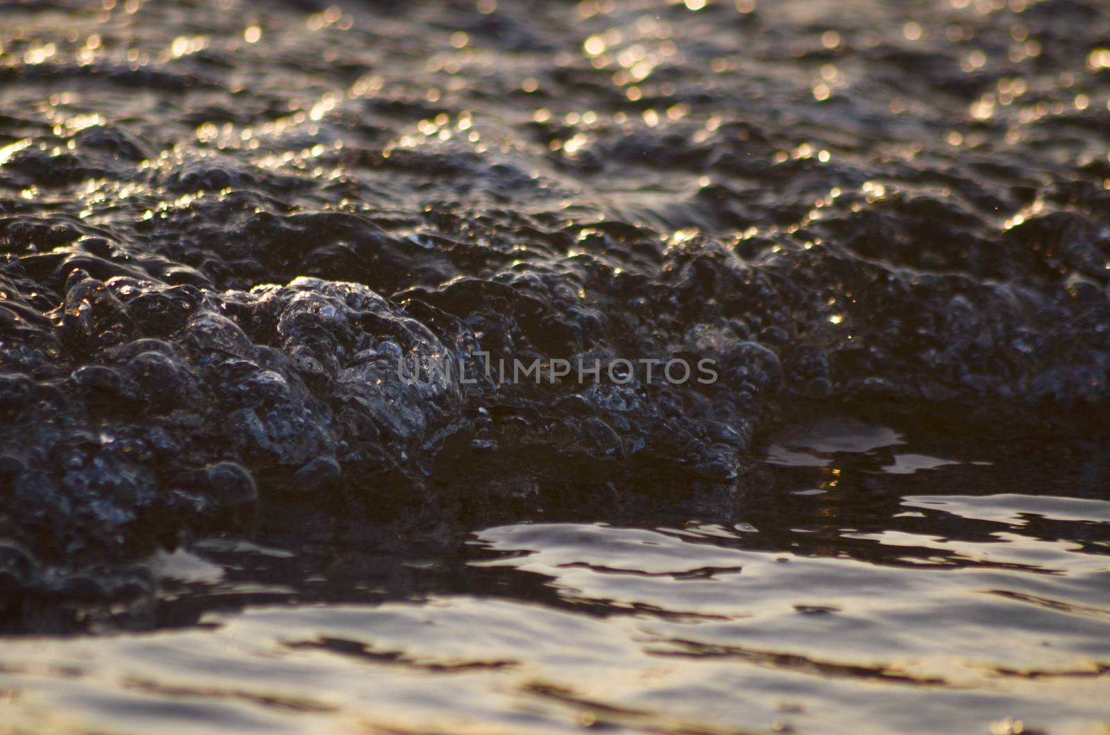 Beach, water under sunset scene in portugal