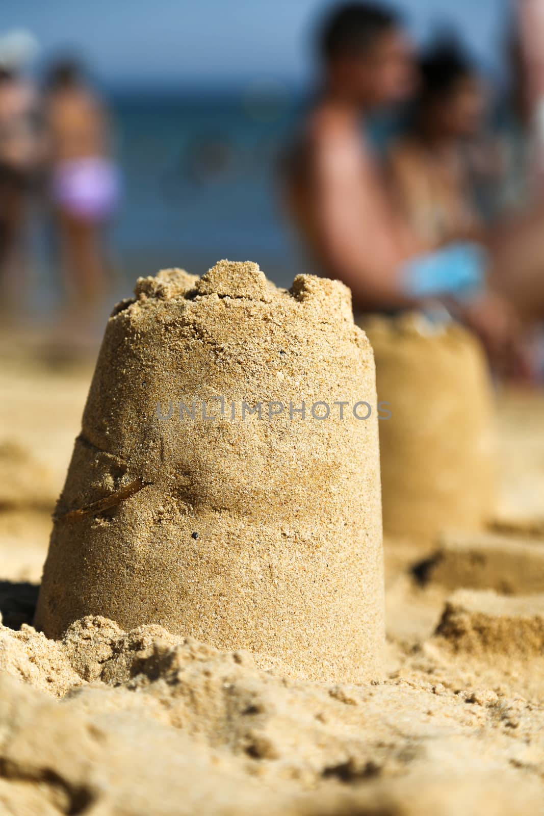 Sand Tower on the beach with blurred people in the background