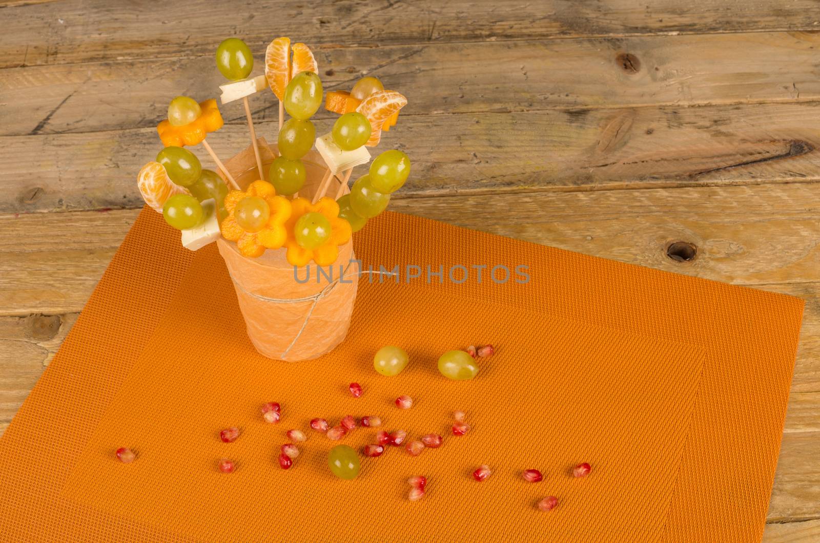 Assorted fruit and cheese decorated to make it attractive for kids
