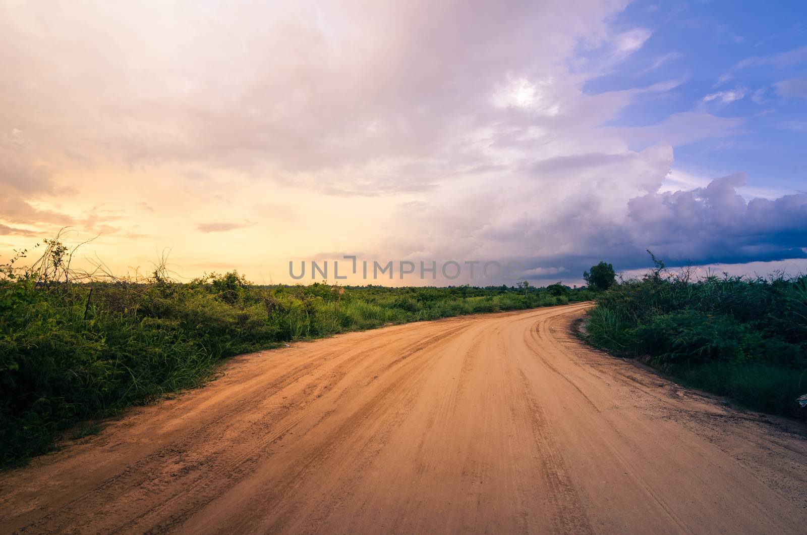 Soil road and grass meadow in  countryside view nature