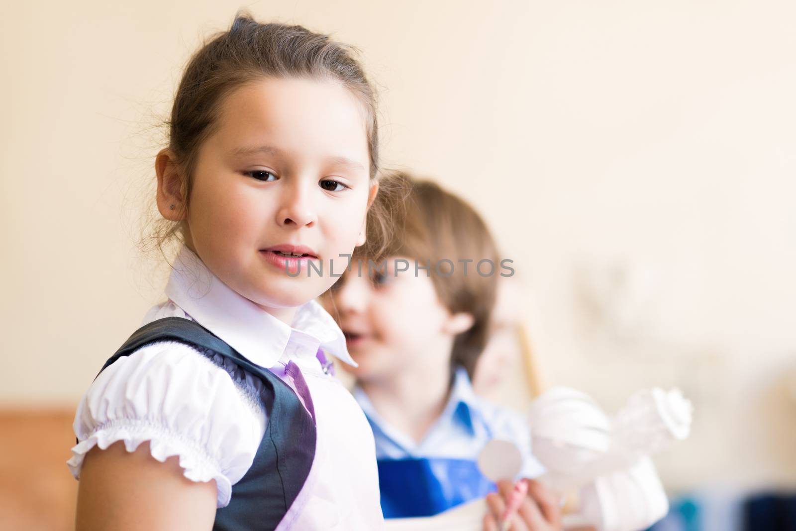 Portrait of Asian girl in apron interested in painting at an art school