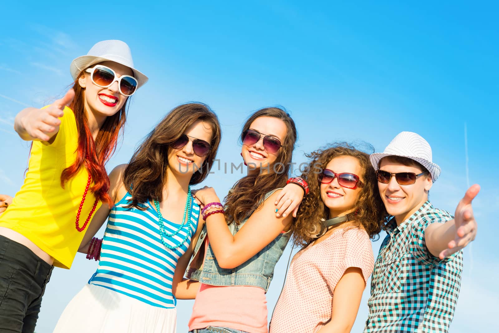 group of young people wearing sunglasses and hats hugging and standing in a row, spending time with friends