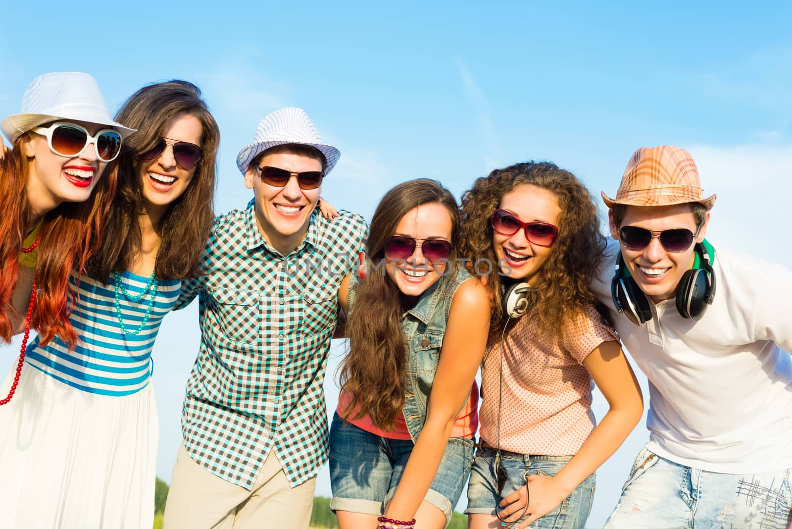 group of young people wearing sunglasses and hats hugging and standing in a row, spending time with friends