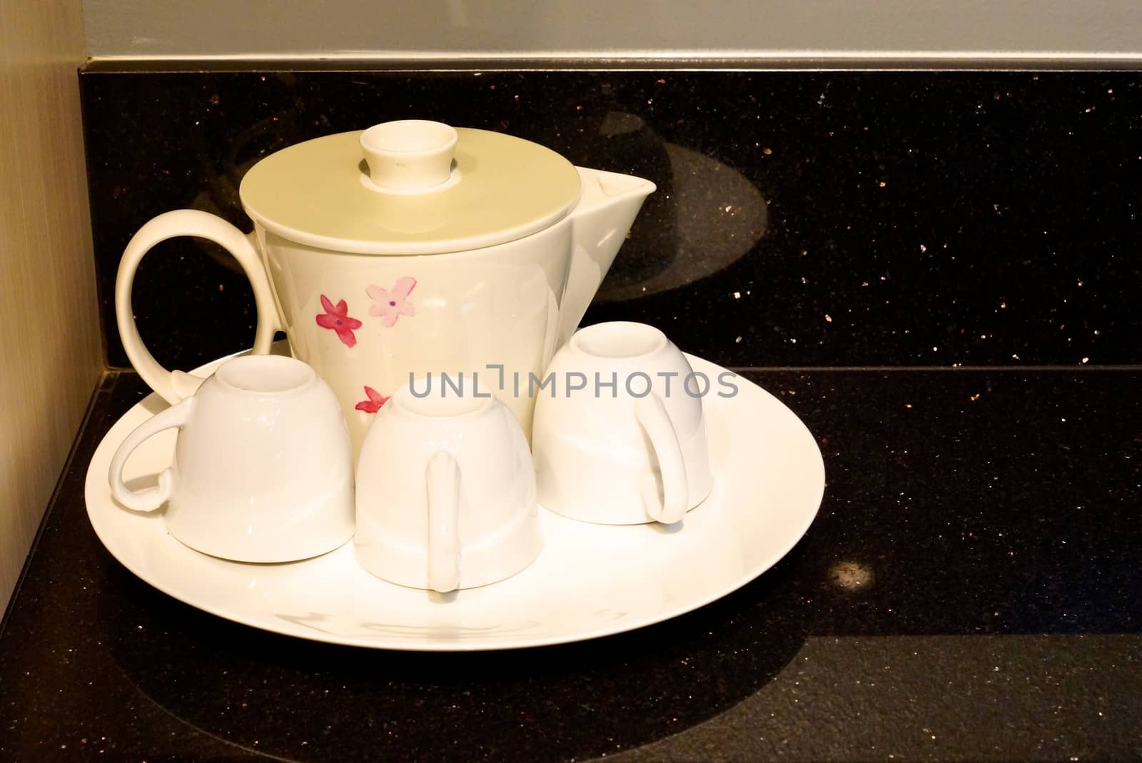 white ceramic tea set on black marble table,shallow focus