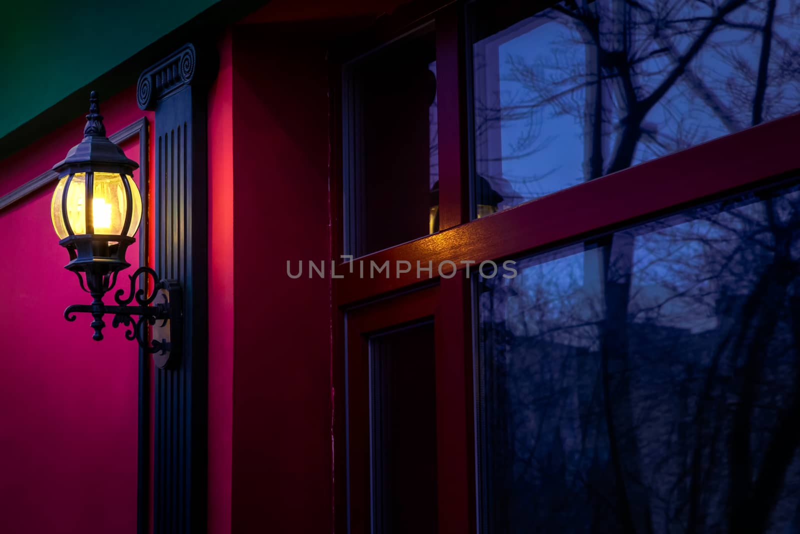 Vintage street lamp at the evening with reflection in window