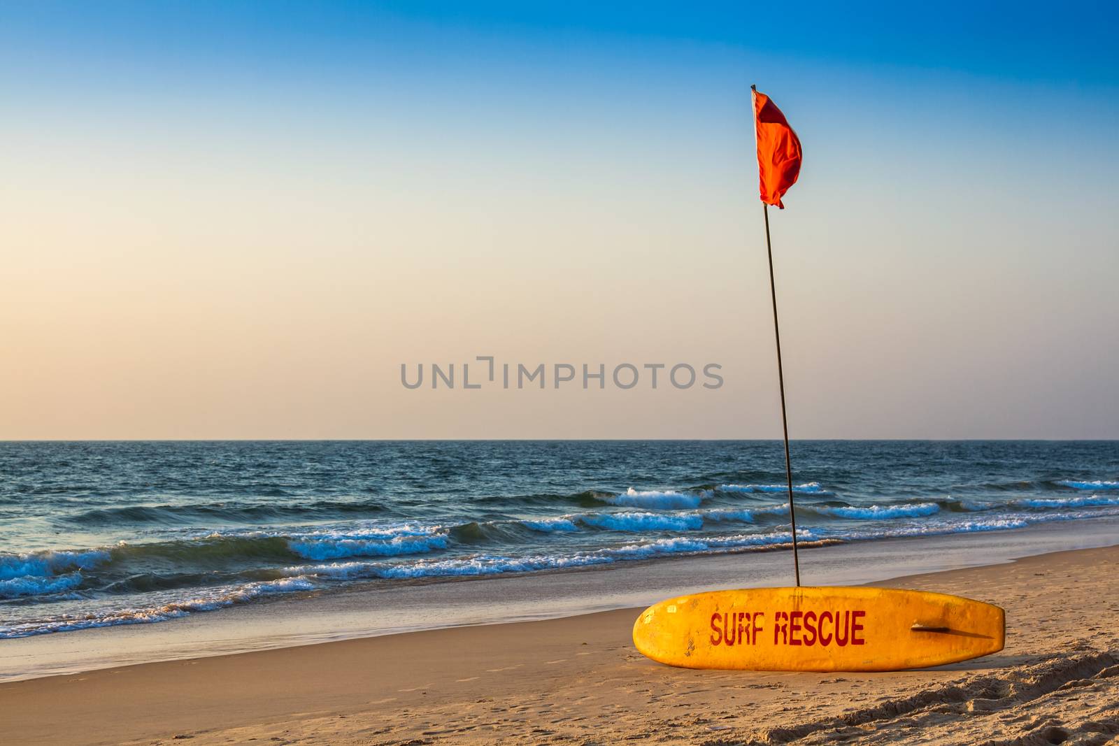 Rescue surfboard on the sand beach near the sea or ocean