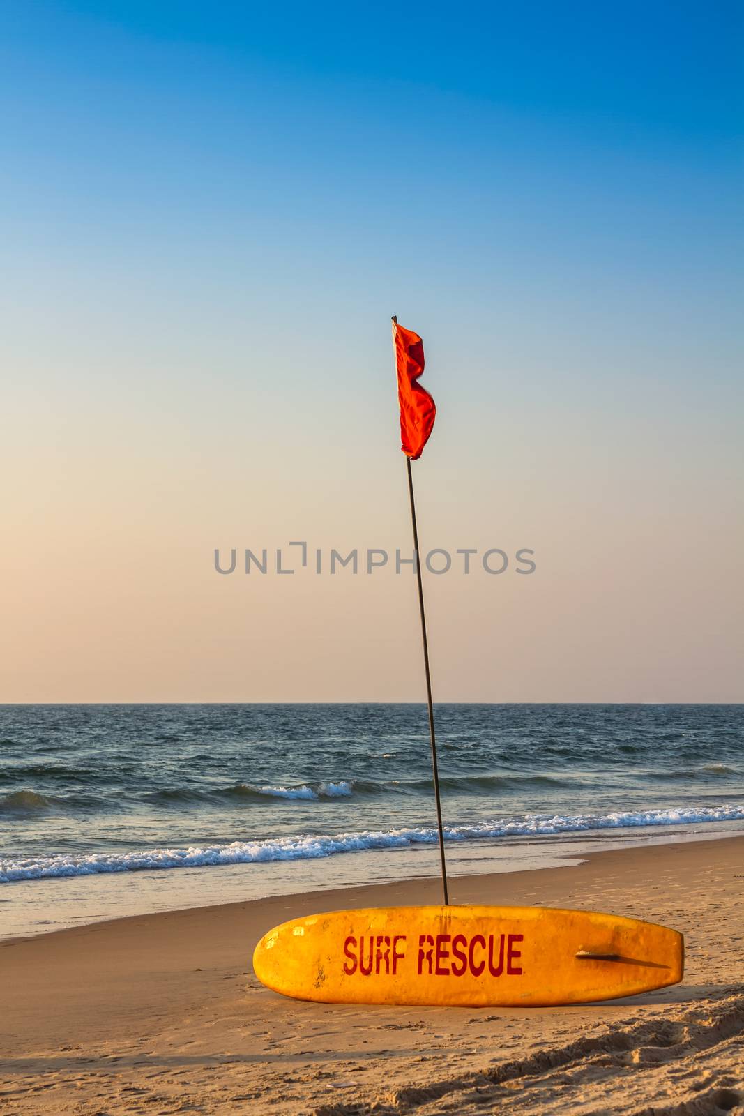Rescue surfboard on the sand beach near the sea or ocean