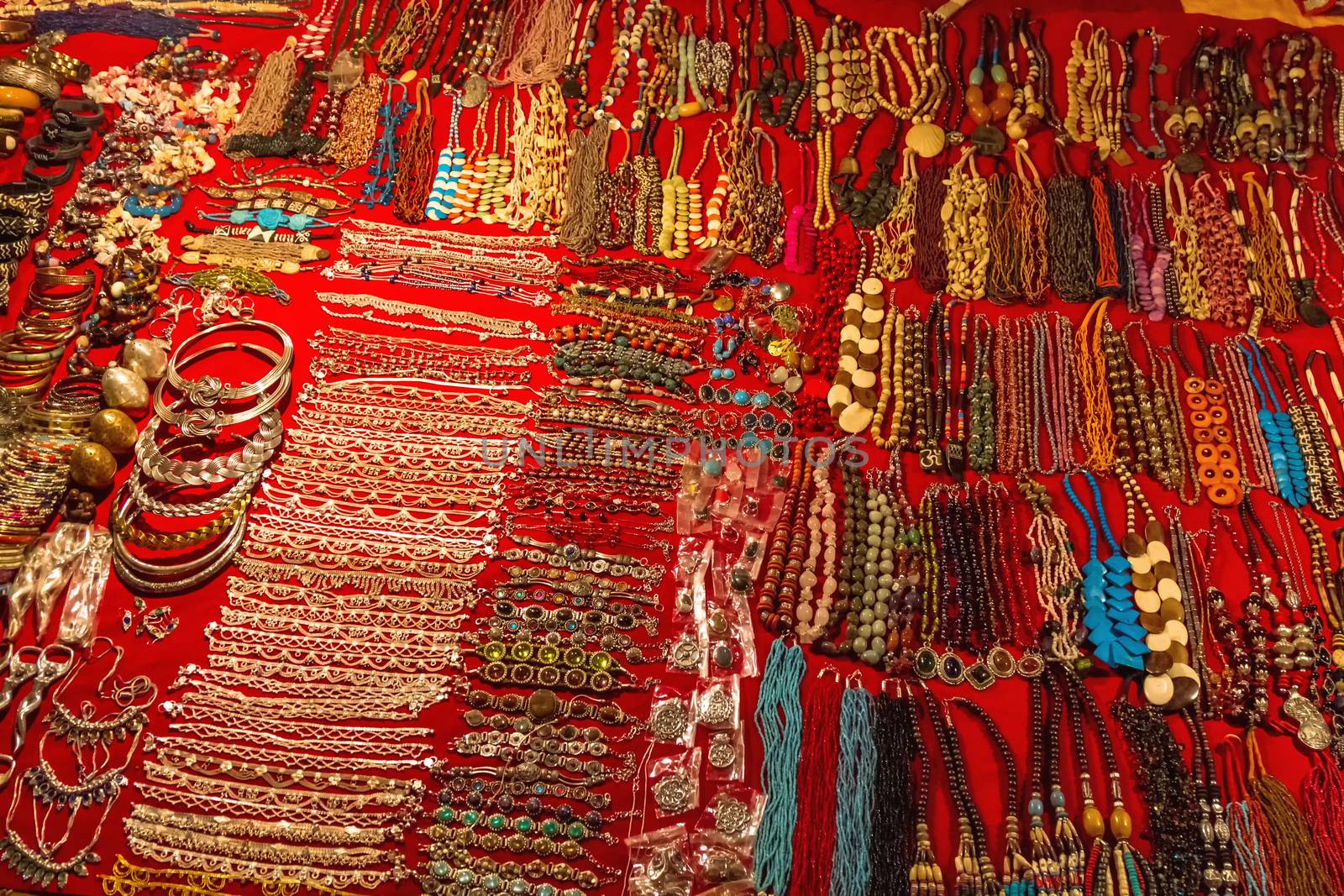 Indian imitation jewelry on the counter of street shop. Night Market in Arpora, Goa, India