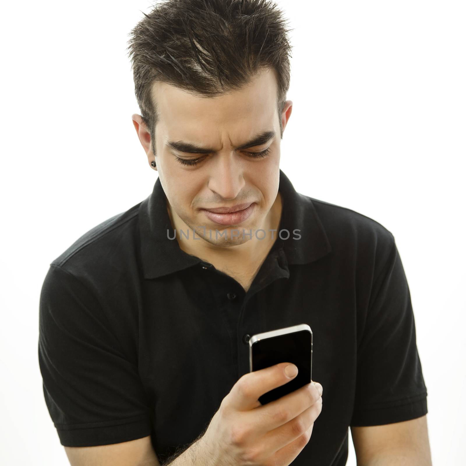 Young man looking at his smartphone annoyed