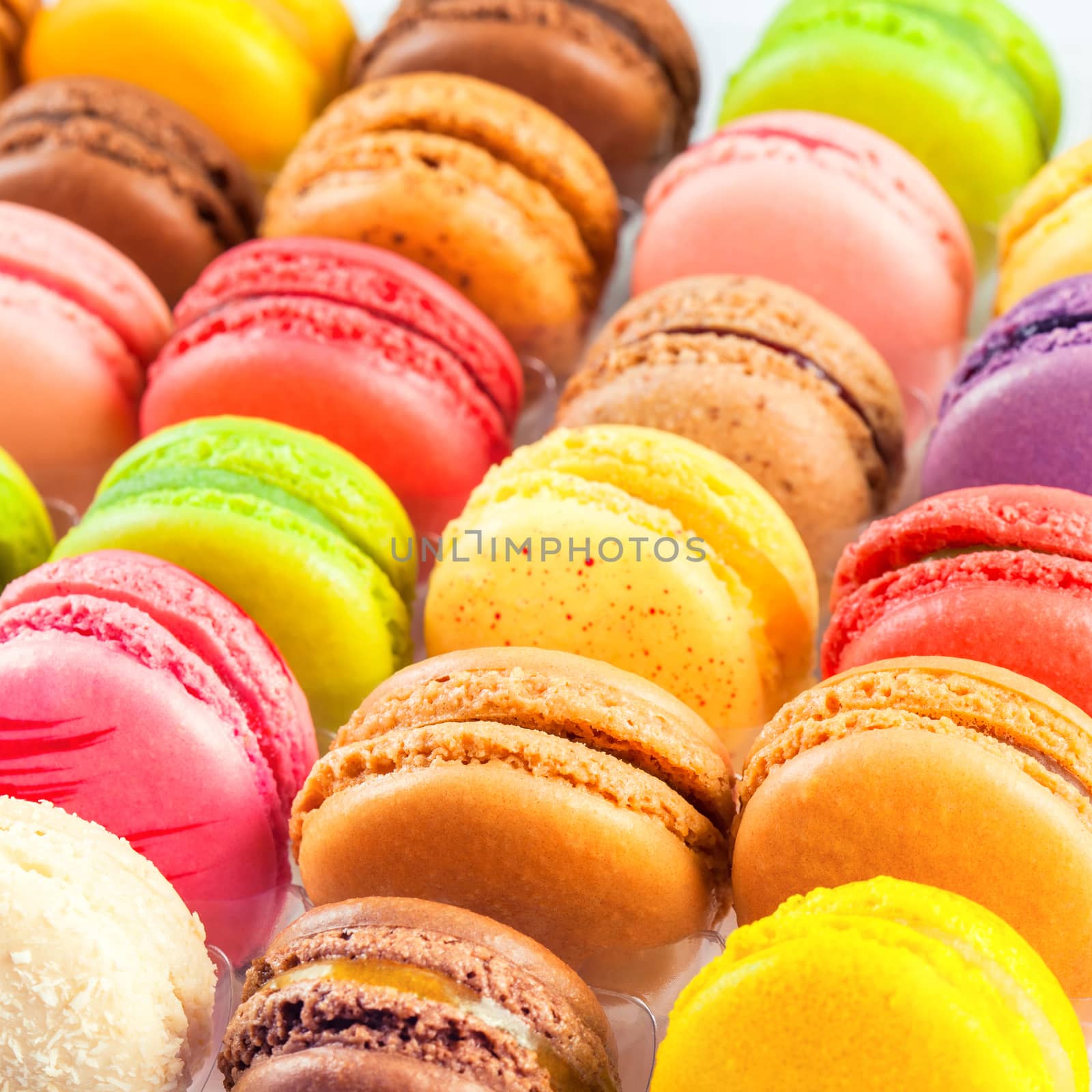 traditional french colorful macarons in a rows in a box