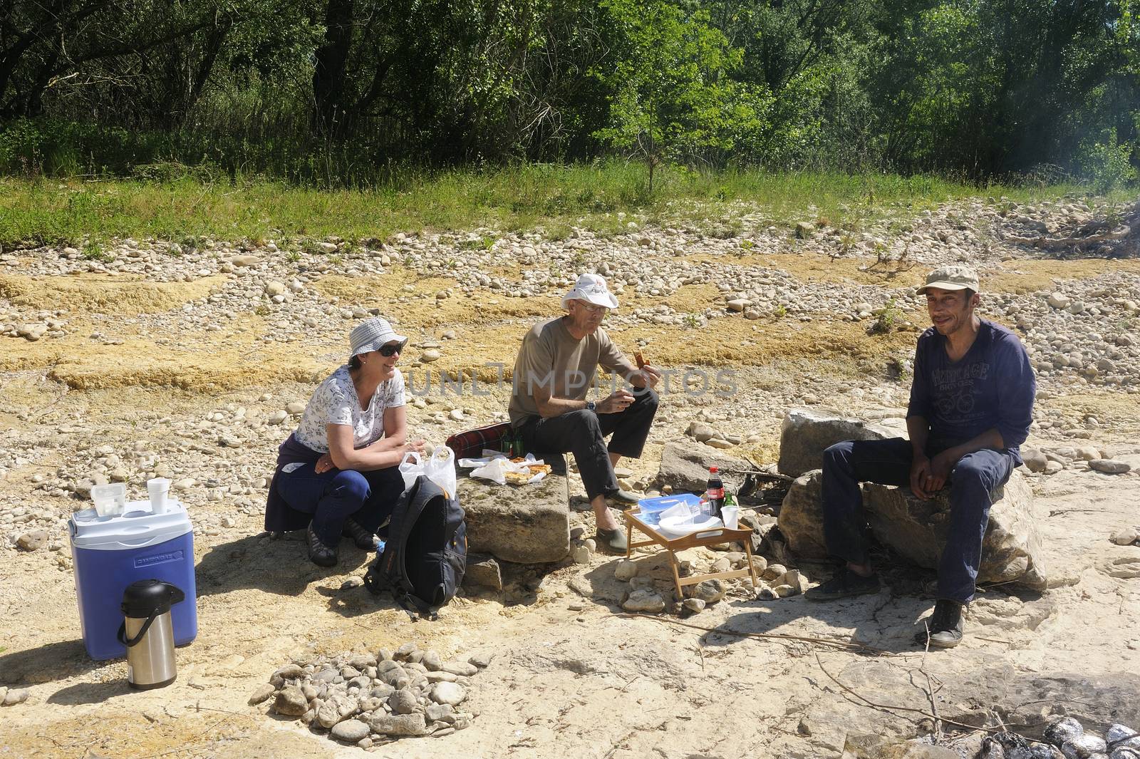 Picnic in walk for friends who have decided to enjoy the first days of spring in the French Cevennes region along the Gardon River in the department of Gard.