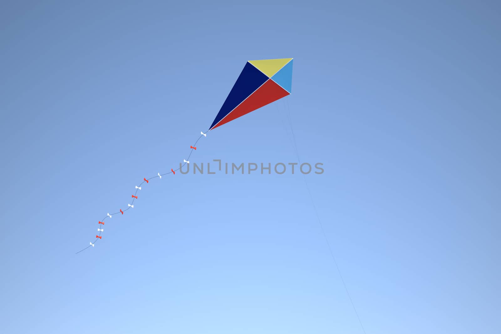 A multicolored kite flying against a blue sky. Detailed 3D render.