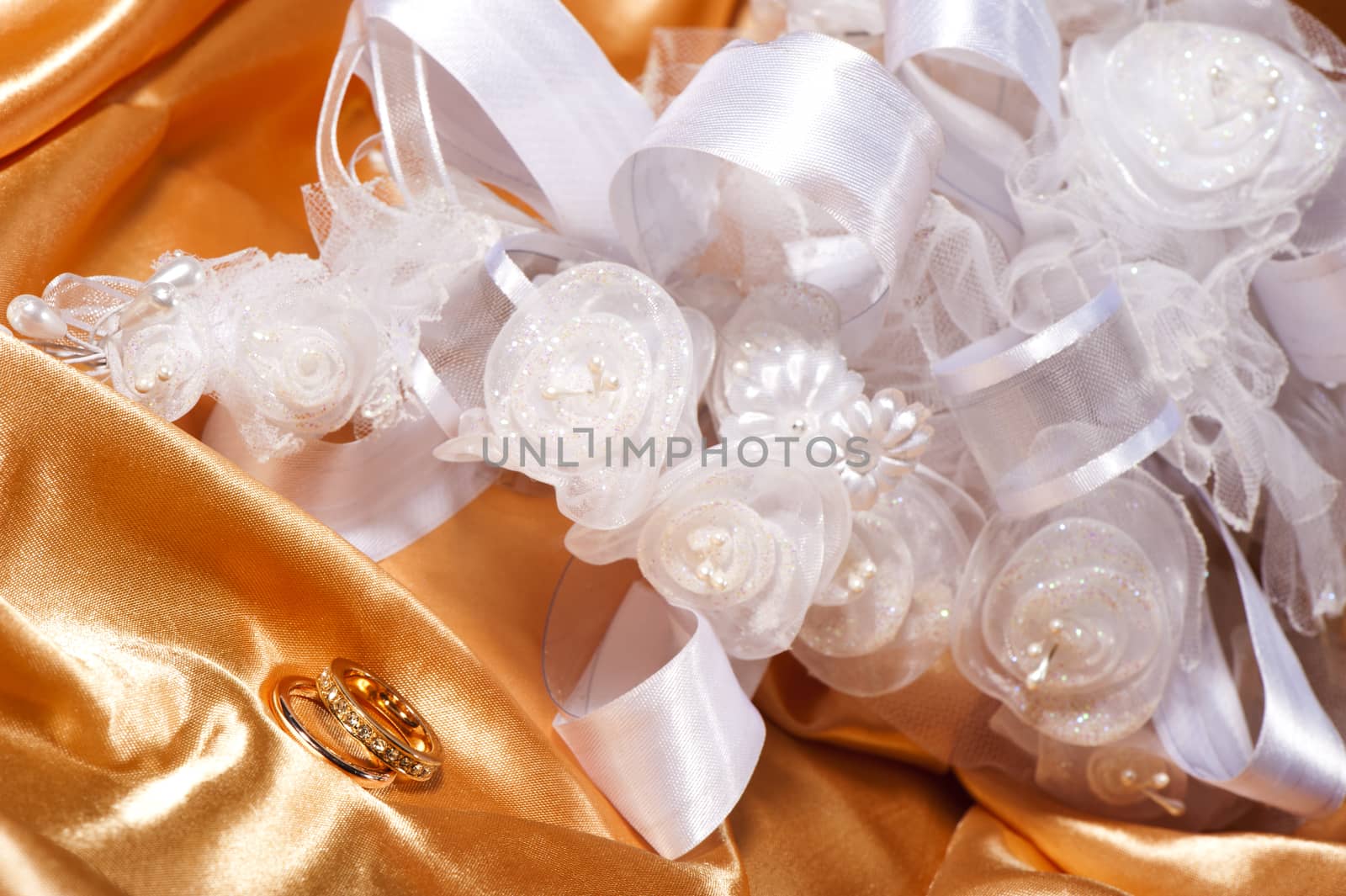  wedding rings on  a colorful fabric background