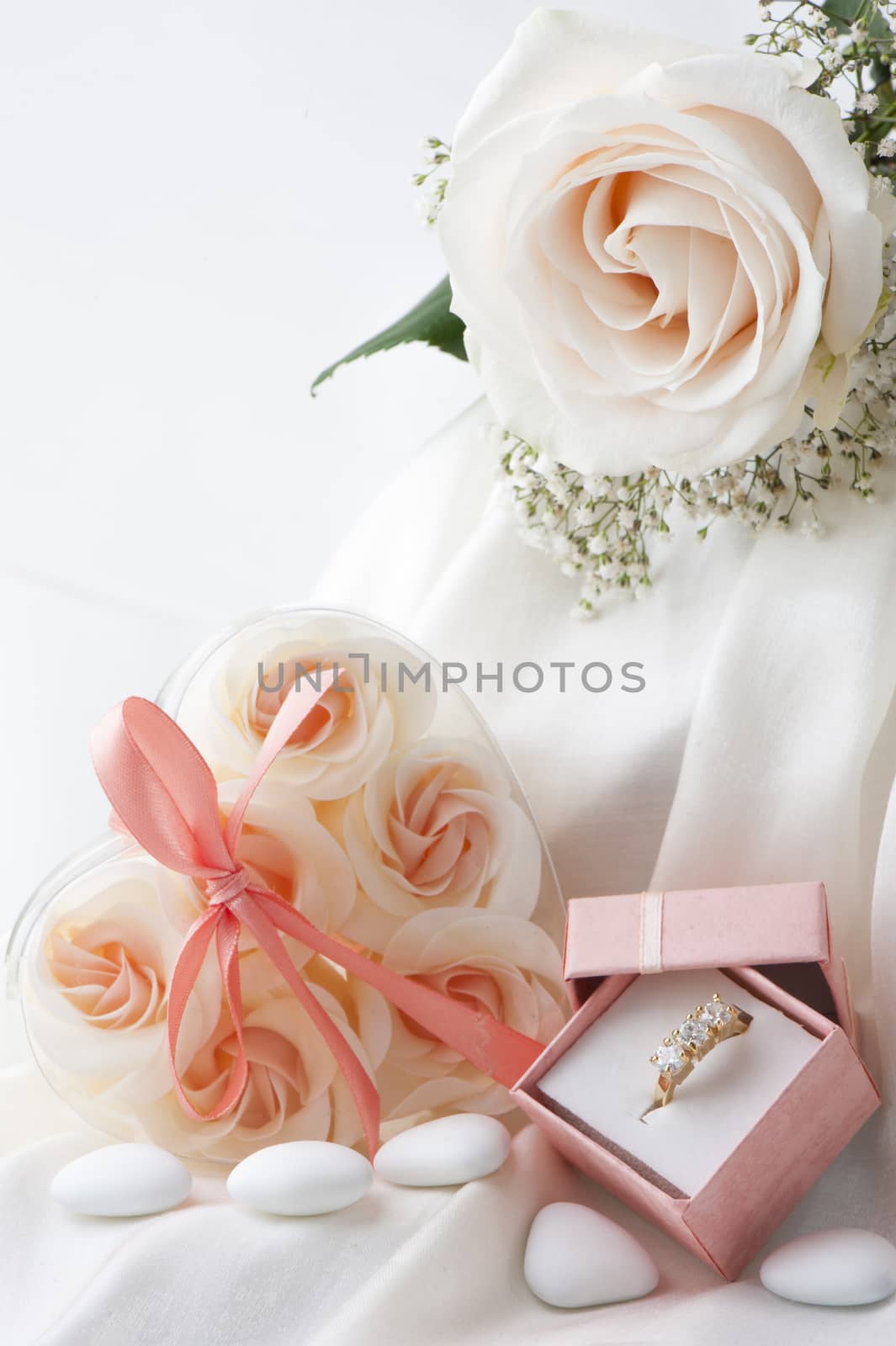 Wedding favors,wedding rings and flowers on white background
