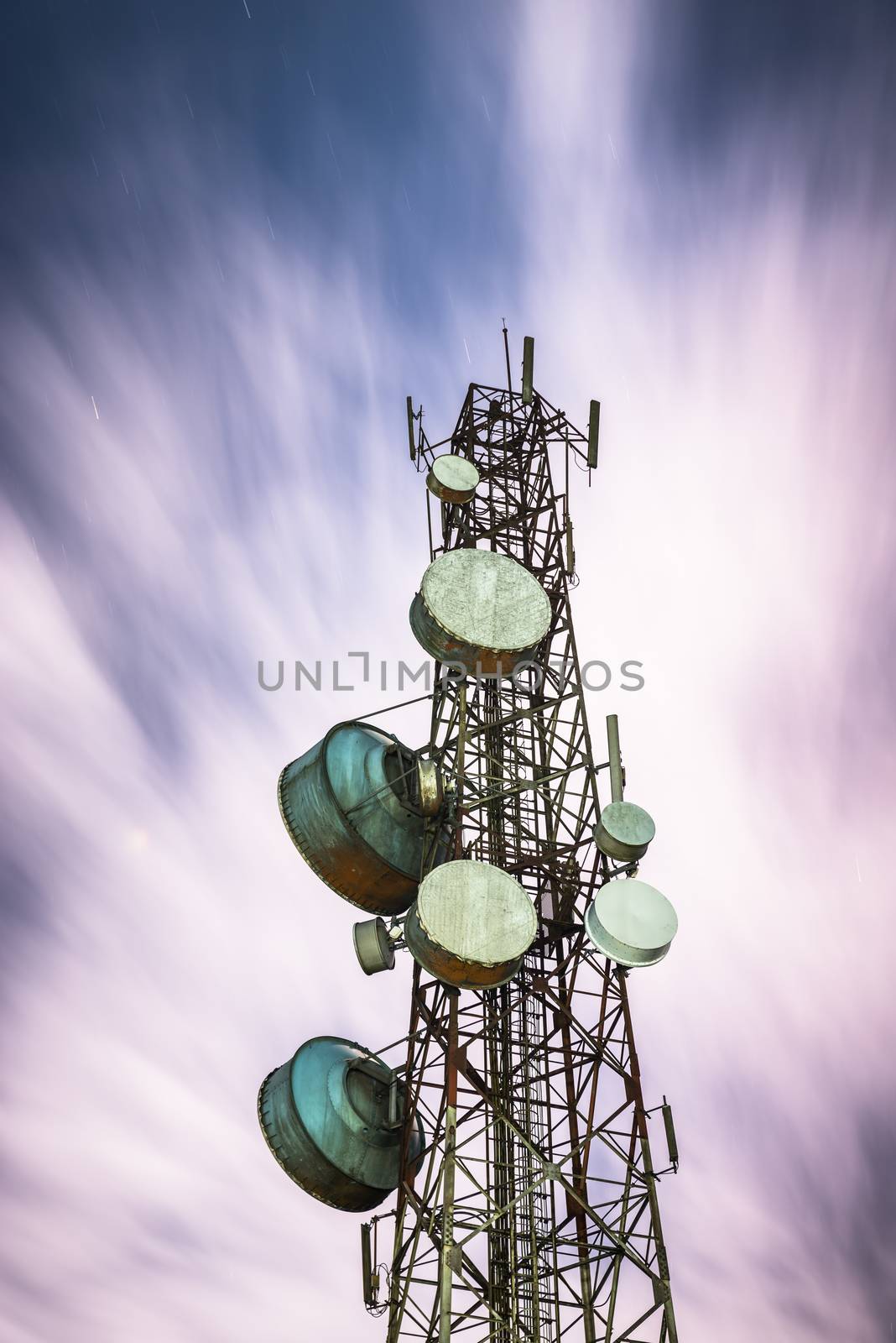 Big communication tower and beautiful longexposure in the night sky