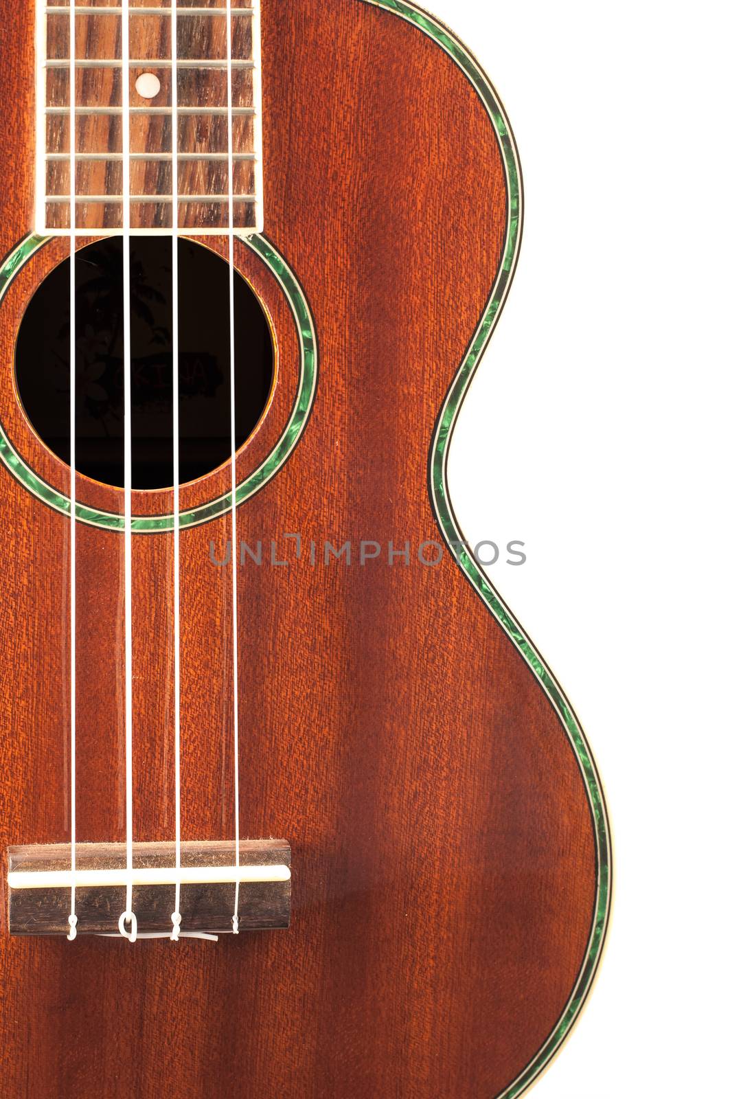 Ukulele guitar brown color and a white background