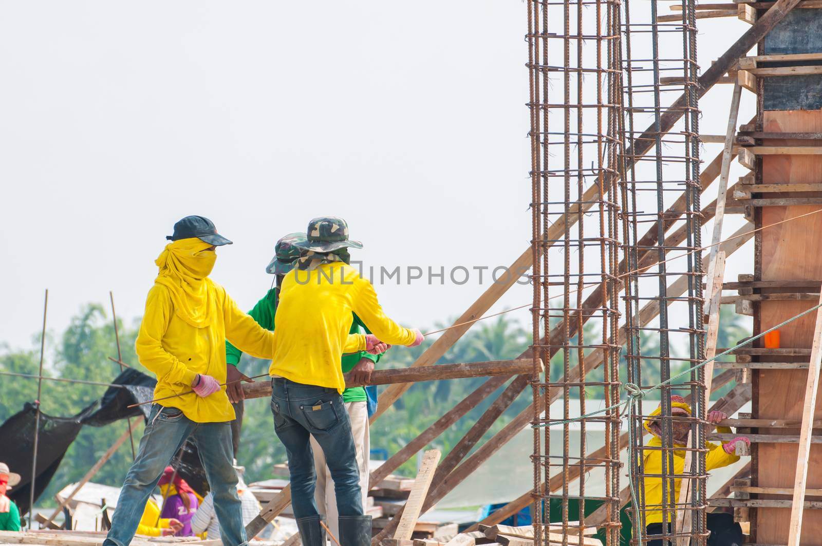 Workers at the construction site  by Sorapop