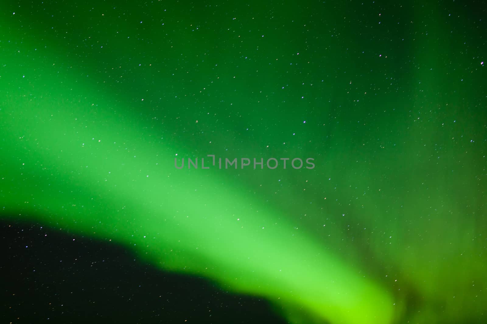 Background texture pattern abstract of green Aurora borealis or northern lights bands on night sky full of stars