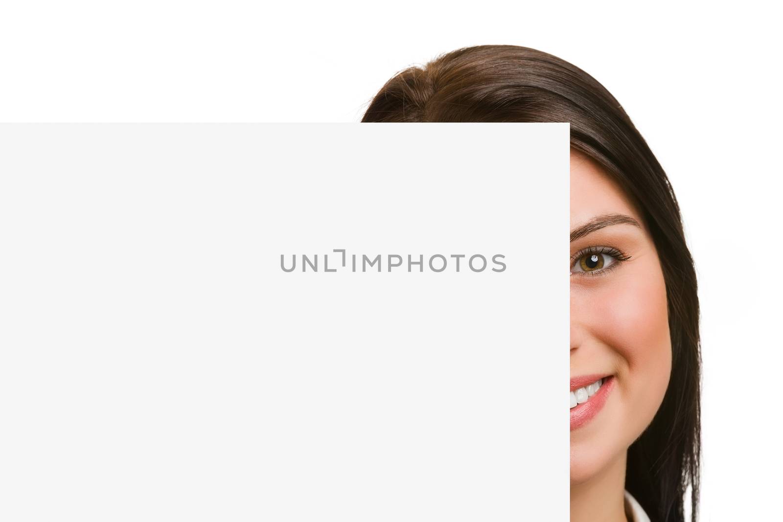 Portrait of half face smiling young woman showing blank signboard