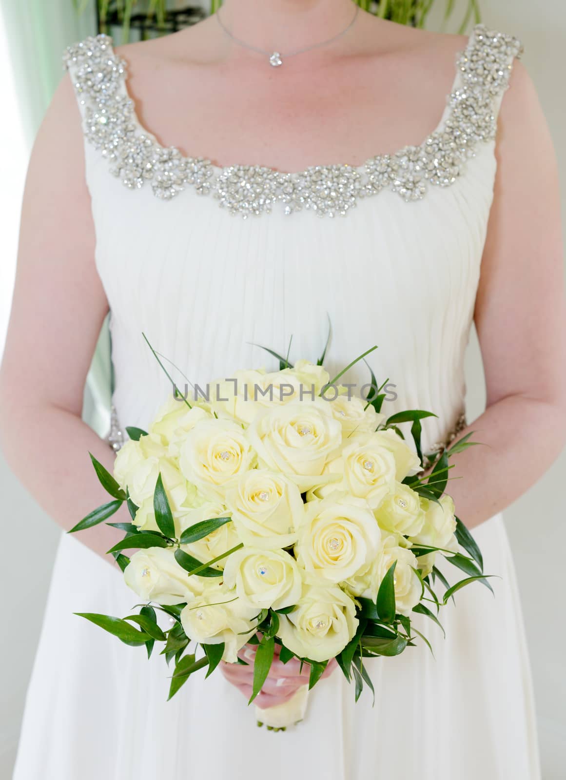 Brides flower arrangement with yellow roses on wedding day