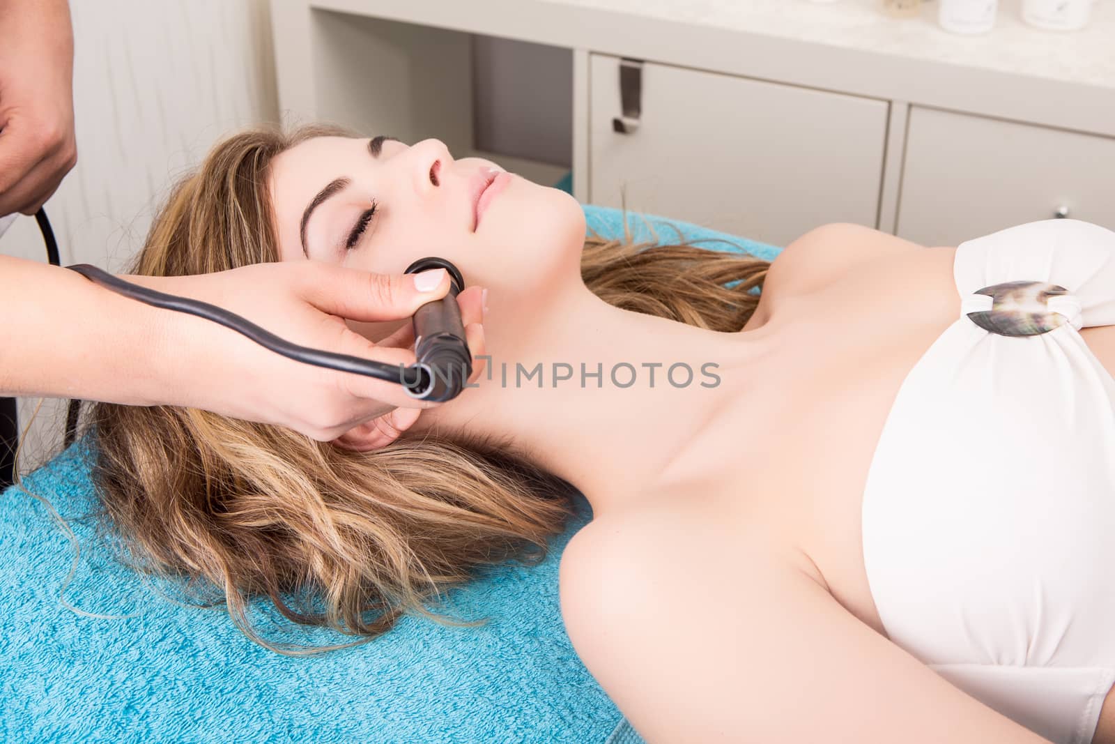 Woman doing cosmetic procedures in spa clinic