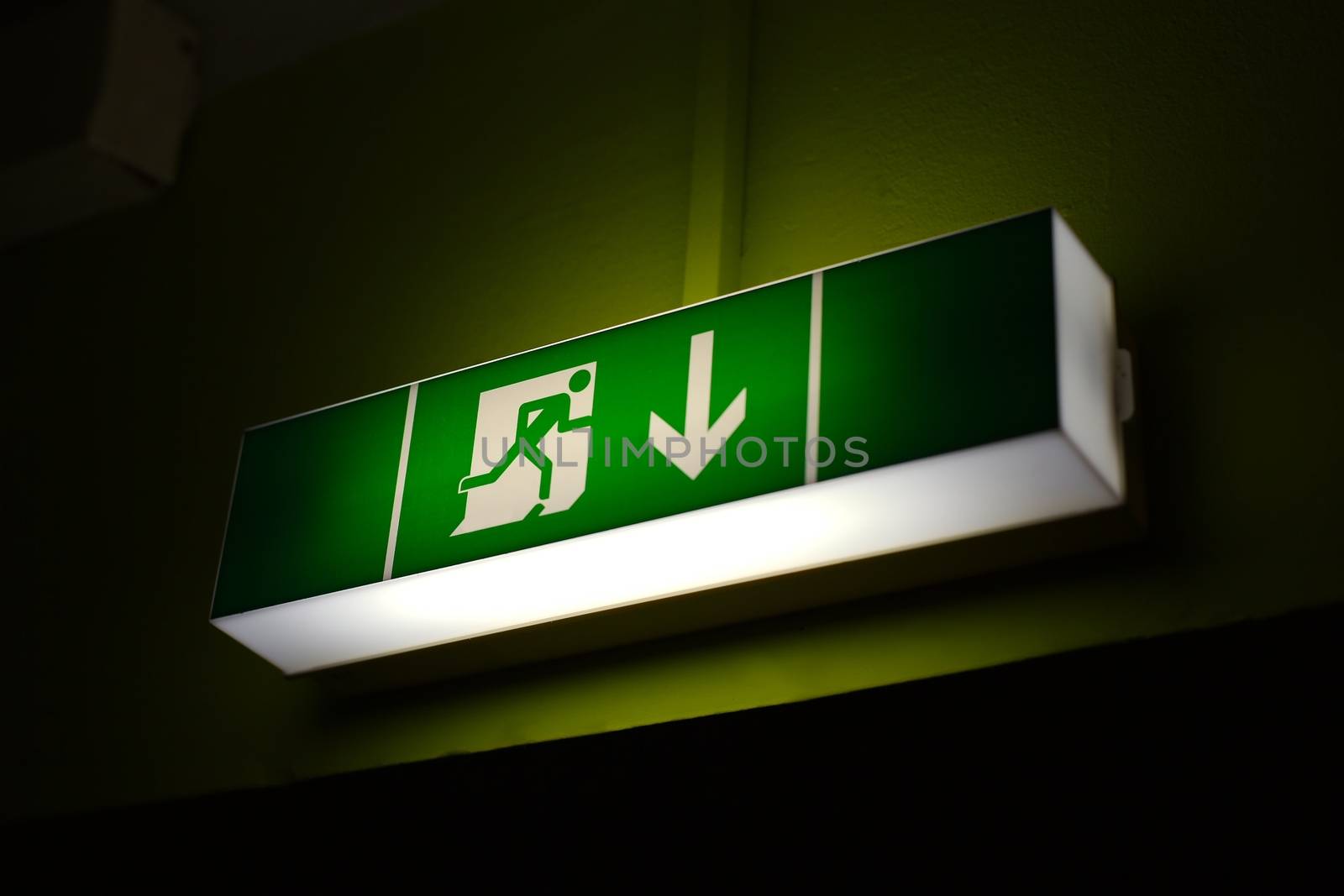 Emergency exit sign glowing in the dark