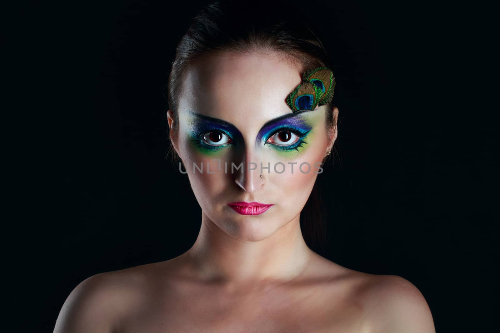 Attractive young girl with makeup peacock bird closeup portrait