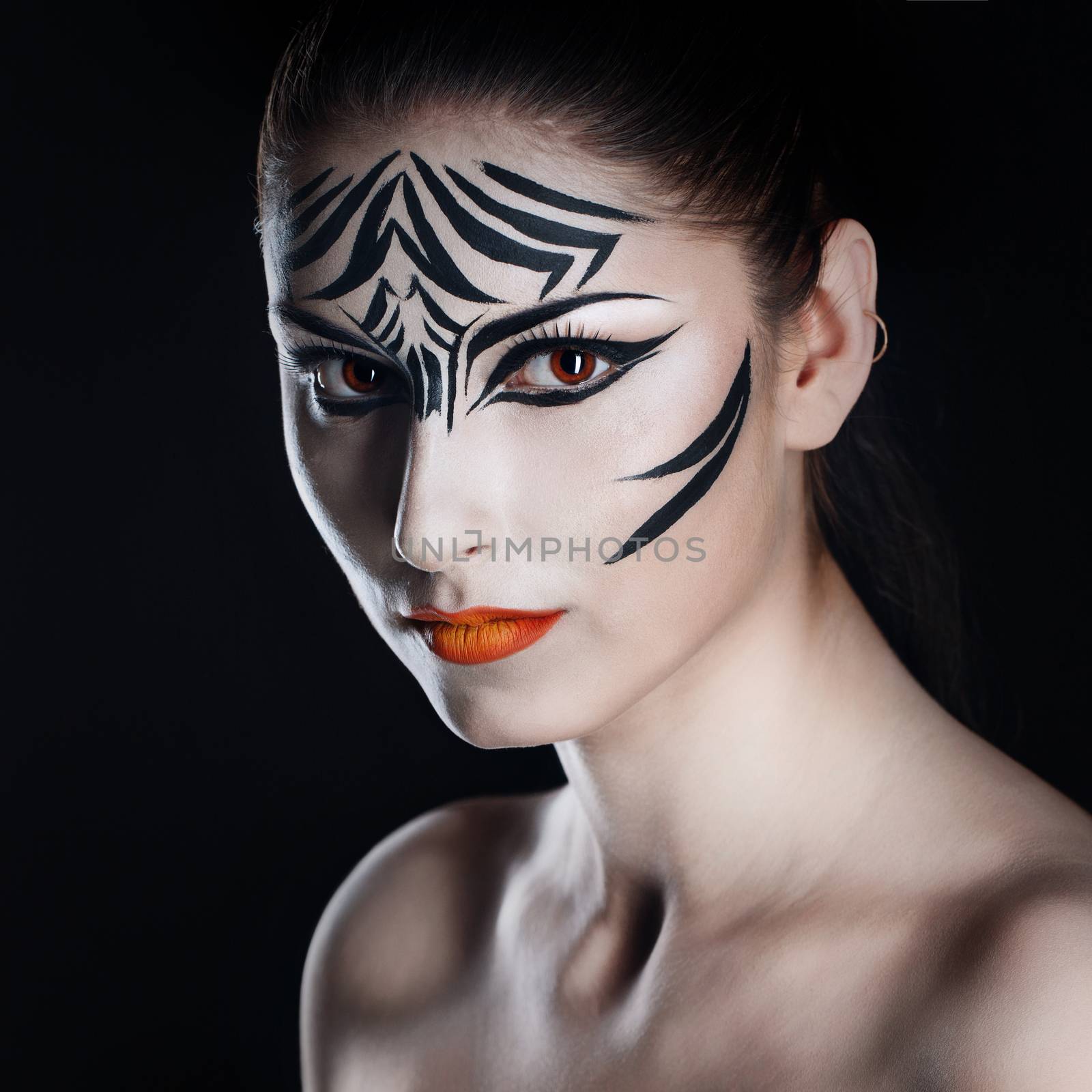 Attractive young girl with make-up of wild zebra close-up portrait
