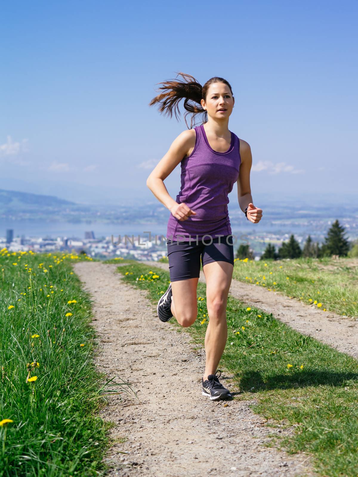 Young fit woman running in spring by sumners