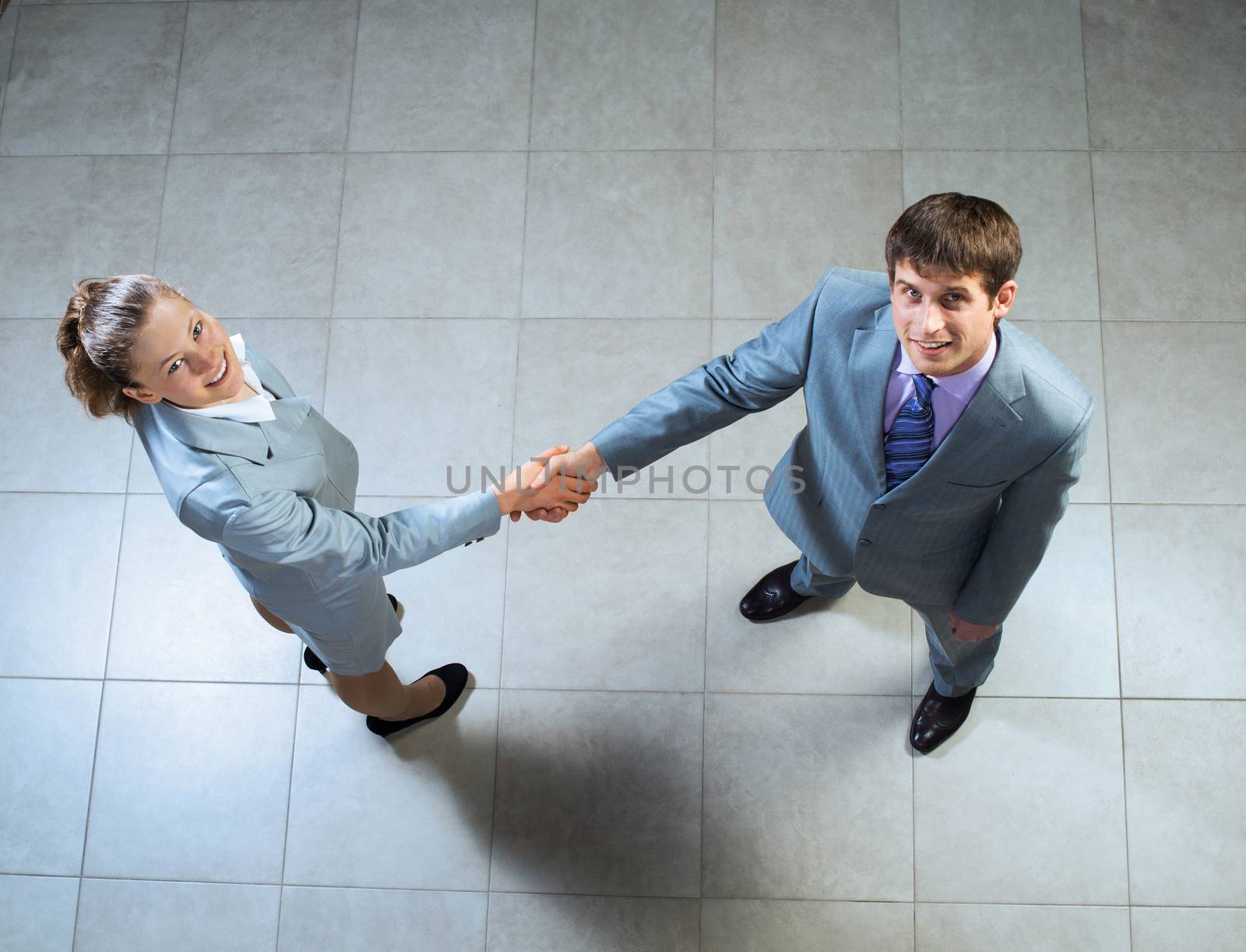 Business woman and businessman shaking hands, reach agreement