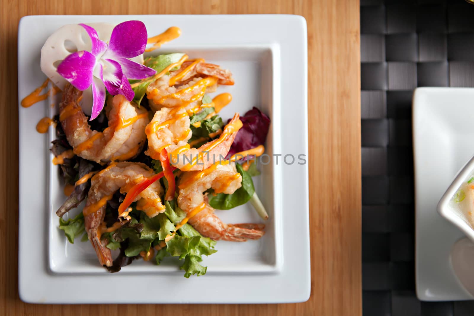 Thai shrimp dish presented on a white square dish.  