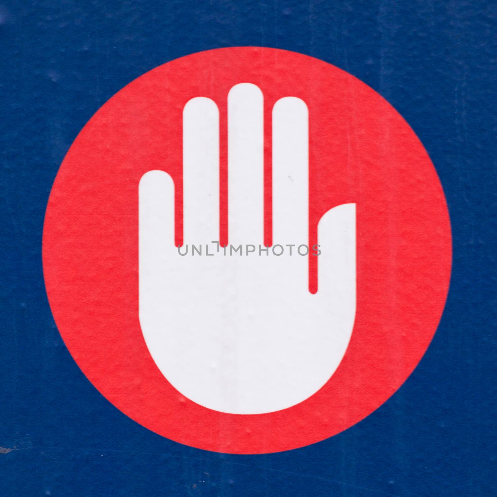 Halt or Stop sign showing the palm of a hand calling a halt, bringing an end to something or forbidding entry