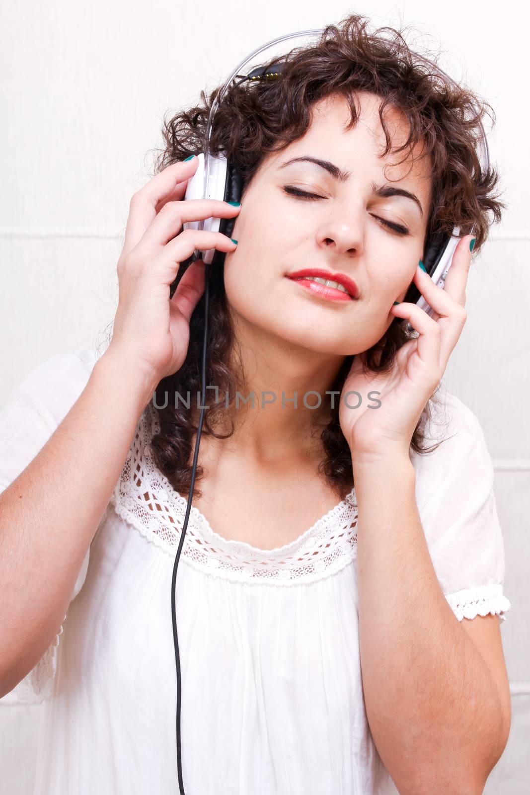 A young woman listening music with Headphones.