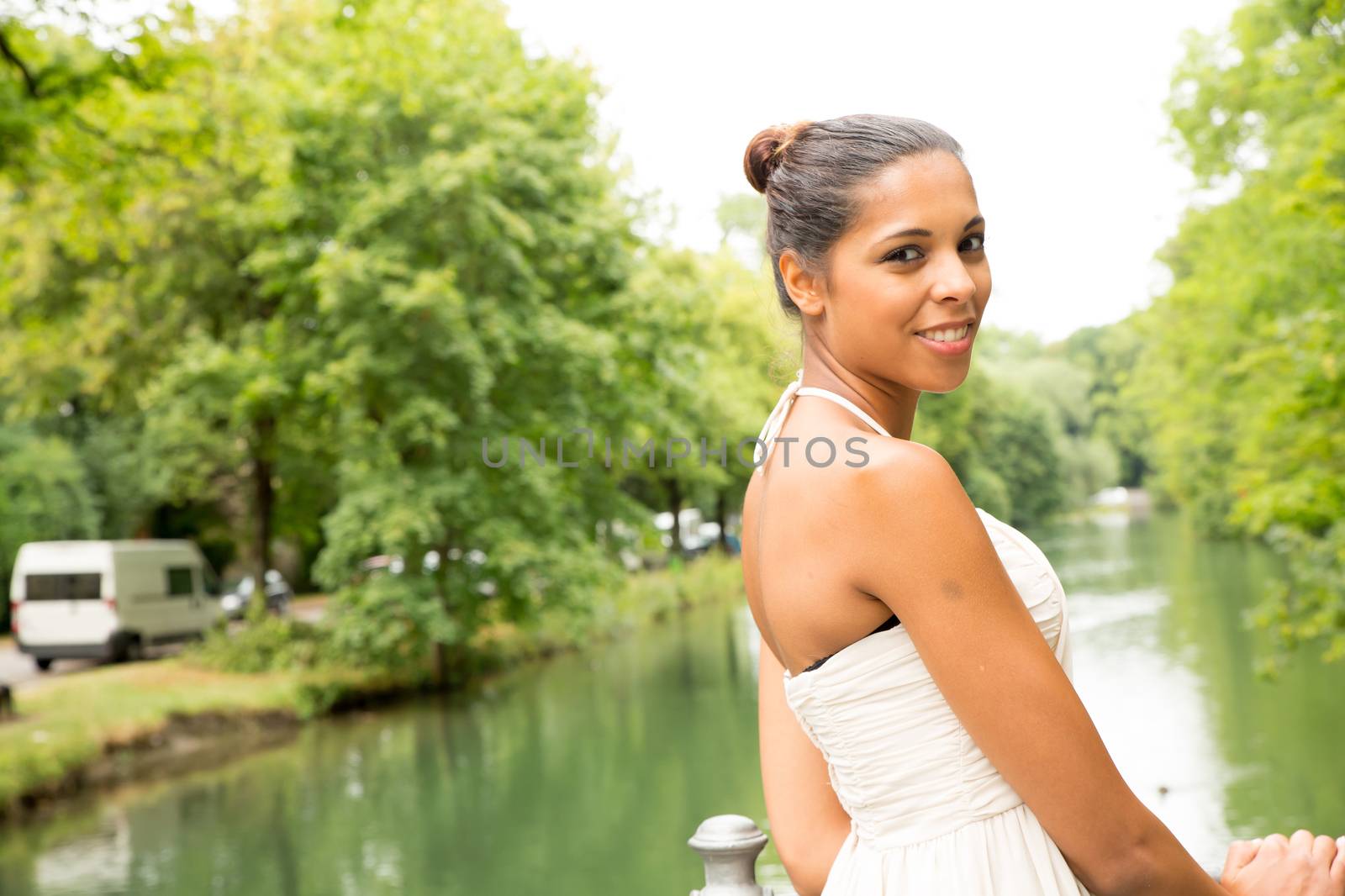 A young girl standing on a bridge.