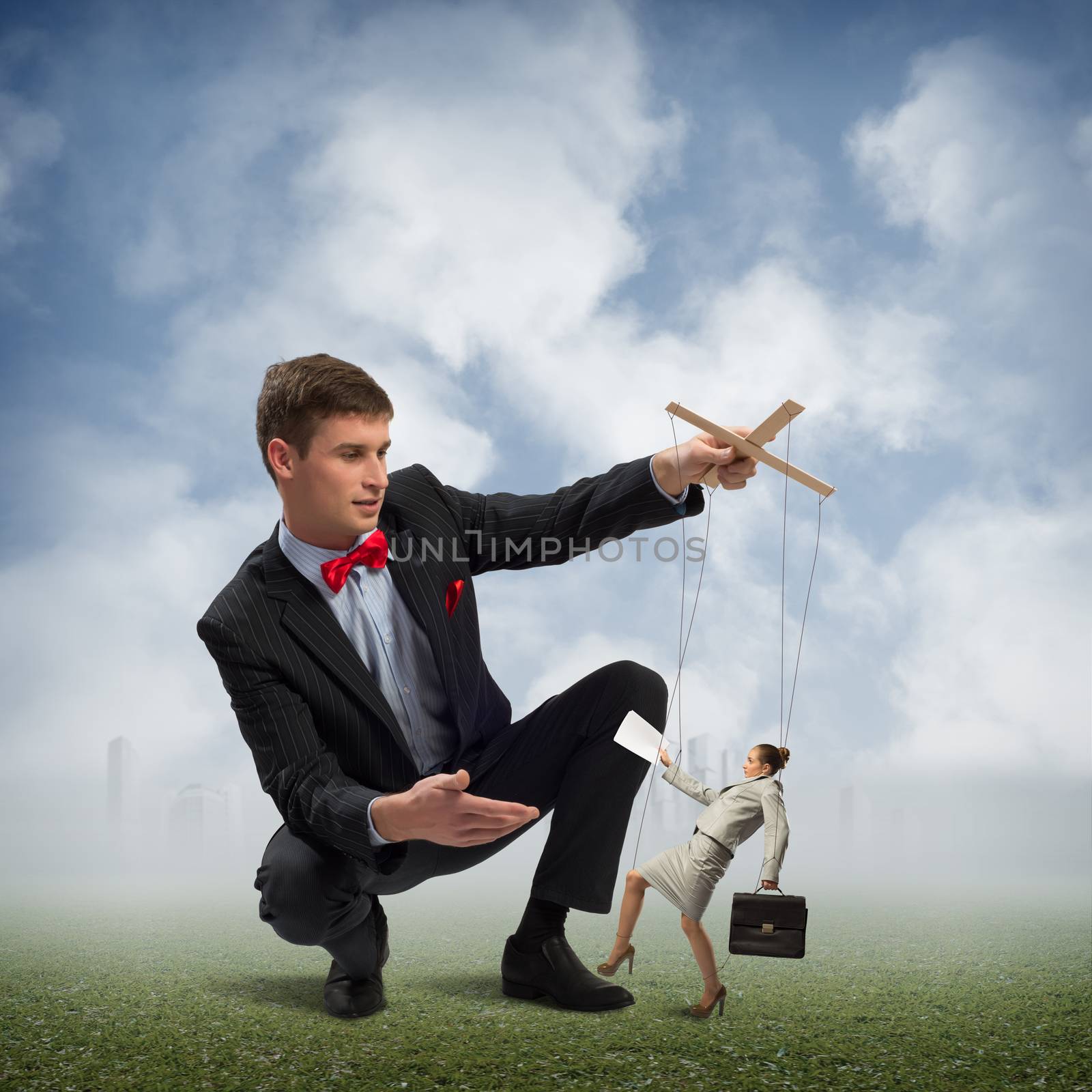 image of a puppeteer holds the puppet business woman