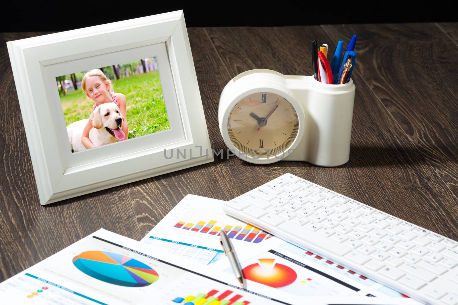 photo frame, business papers with financial charts. Workplace of the businessman.