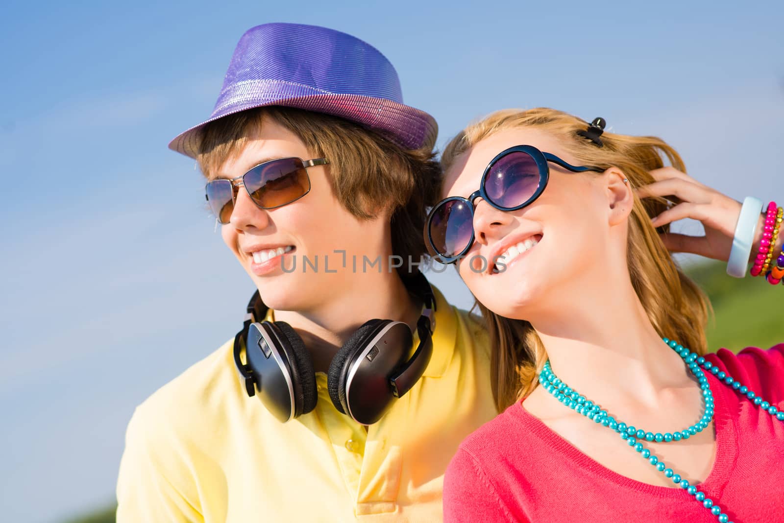 young couple standing on the road, having fun with friends