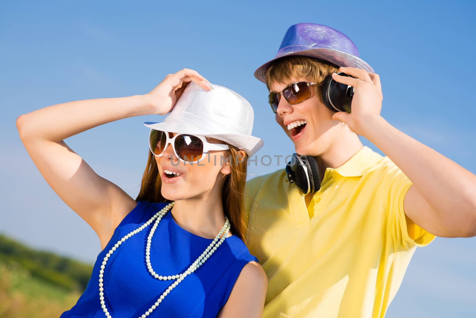 young couple standing on the road, having fun with friends